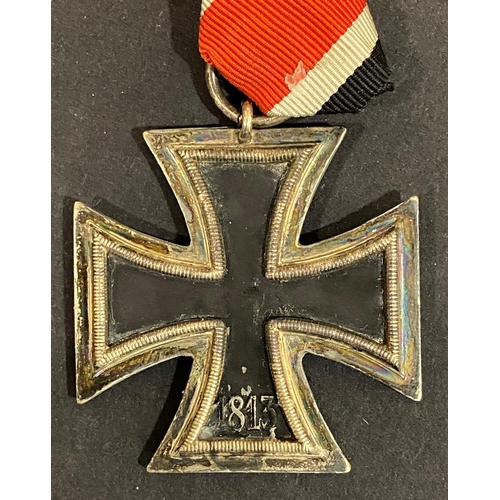 510 - A SECOND WORLD WAR GERMAN IRON CROSS 2ND CLASS. A German Iron Cross dated 1939, on a short length of... 