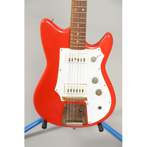 521 - FUTURAMA ELECTRIC GUITAR. A small Futurama II electric guitar with red and white body, Serial Number... 