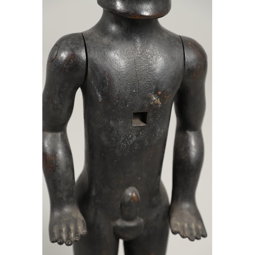 527 - TRIBAL INTEREST - A LARGE CARVED ARTICULATED FIGURE. A large carved hardwood male figure, with artic... 