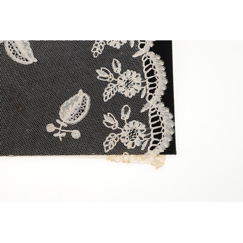 537 - QUEEN VICTORIA INTEREST - HONITON LACE BERTHA. A 19thc Honiton lace bertha, mounted on a piece of bl... 