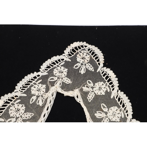 537 - QUEEN VICTORIA INTEREST - HONITON LACE BERTHA. A 19thc Honiton lace bertha, mounted on a piece of bl... 