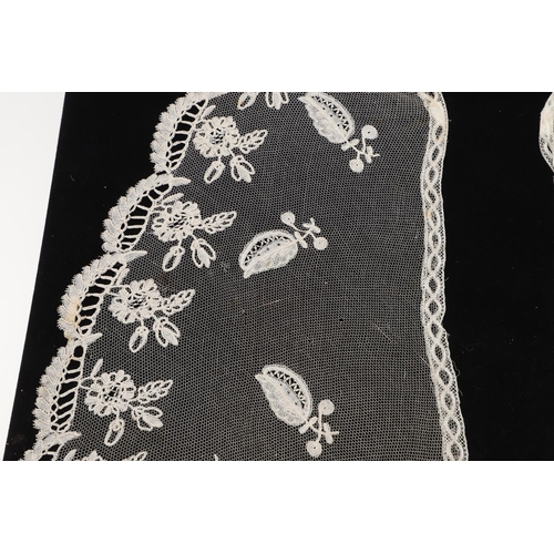 537 - QUEEN VICTORIA INTEREST - HONITON LACE BERTHA. A 19thc Honiton lace bertha, mounted on a piece of bl... 