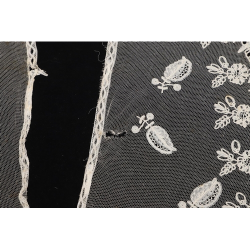 537 - QUEEN VICTORIA INTEREST - HONITON LACE BERTHA. A 19thc Honiton lace bertha, mounted on a piece of bl... 