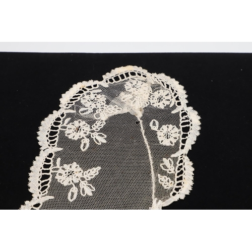 537 - QUEEN VICTORIA INTEREST - HONITON LACE BERTHA. A 19thc Honiton lace bertha, mounted on a piece of bl... 