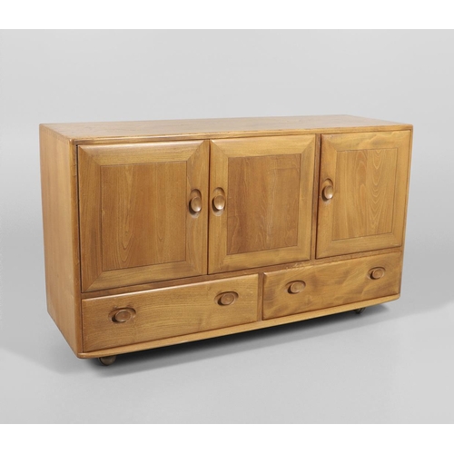 660 - VINTAGE ERCOL ELM SIDEBOARD. A vintage light elm sideboard with two door cupboard and internal shelf... 