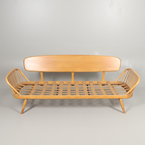 662 - VINTAGE ERCOL DAY BED. A vintage elm and beech day bed or couch, with a single plank back and spindl... 