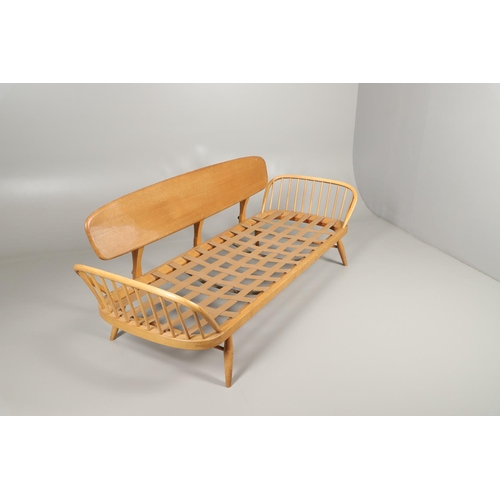 662 - VINTAGE ERCOL DAY BED. A vintage elm and beech day bed or couch, with a single plank back and spindl... 