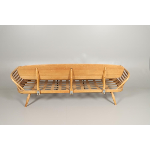 662 - VINTAGE ERCOL DAY BED. A vintage elm and beech day bed or couch, with a single plank back and spindl... 