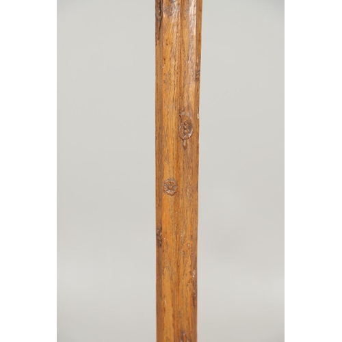 669 - ARTS & CRAFTS OAK STANDARD LAMP. In the style of Robert Thompson of Kilburn (Mouseman), of octagonal... 