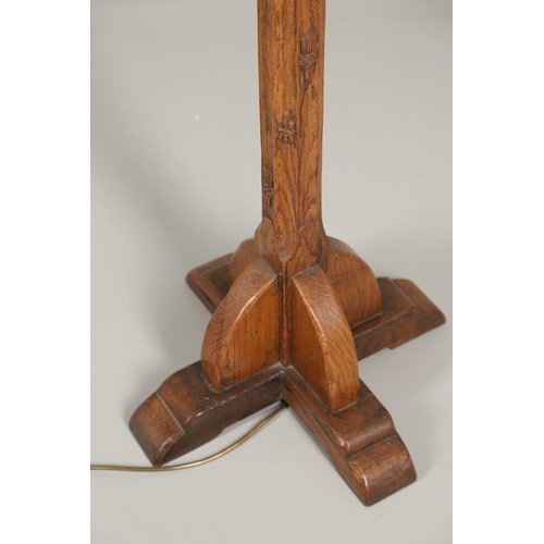 669 - ARTS & CRAFTS OAK STANDARD LAMP. In the style of Robert Thompson of Kilburn (Mouseman), of octagonal... 