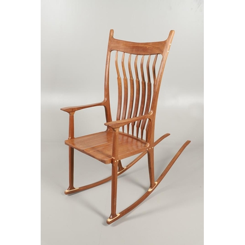 676 - AFTER SAM MALOOF - DESIGNER ROCKING CHAIR. A large designer rocking chair after a design by Sam Malo... 