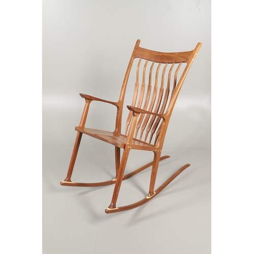 676 - AFTER SAM MALOOF - DESIGNER ROCKING CHAIR. A large designer rocking chair after a design by Sam Malo... 