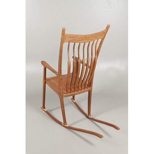 676 - AFTER SAM MALOOF - DESIGNER ROCKING CHAIR. A large designer rocking chair after a design by Sam Malo... 