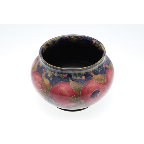 687 - EARLY MOORCROFT POMEGRANATE & MOORCROFT VASE. A early jardiniere of globular form in the pomegranate... 