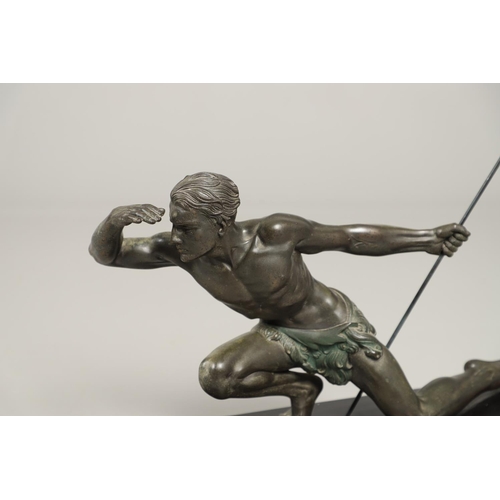 716 - JEAN DE RONCOURT - FRENCH ART DECO SPELTER FIGURE. A patinated spelter figure of a hunter holding a ... 