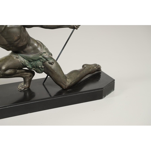 716 - JEAN DE RONCOURT - FRENCH ART DECO SPELTER FIGURE. A patinated spelter figure of a hunter holding a ... 