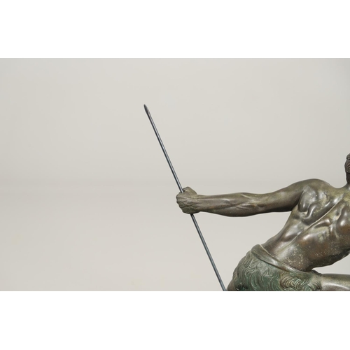 716 - JEAN DE RONCOURT - FRENCH ART DECO SPELTER FIGURE. A patinated spelter figure of a hunter holding a ... 