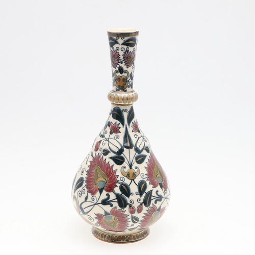 722 - ZSOLNAY PECS VASE. A bottle shaped vase painted with a Persian style design of flowers and leaves. M... 