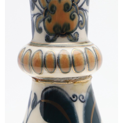 722 - ZSOLNAY PECS VASE. A bottle shaped vase painted with a Persian style design of flowers and leaves. M... 