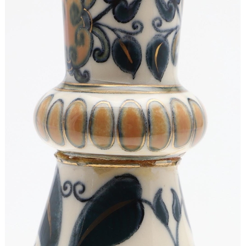 722 - ZSOLNAY PECS VASE. A bottle shaped vase painted with a Persian style design of flowers and leaves. M... 