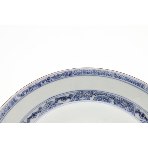 793 - 18THC CHINESE BLUE & WHITE DISH. An 18thc dish or bowl of shallow form, painted with a central flowe... 