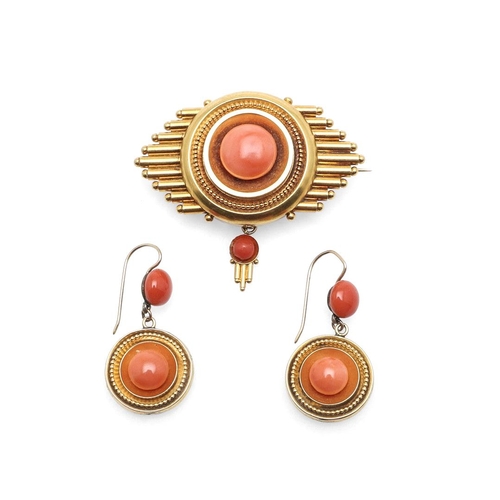 1000 - A VICTORIAN CORAL AND GOLD BROOCH. the gold mount is centred with a circular coral cabochon, with lo... 