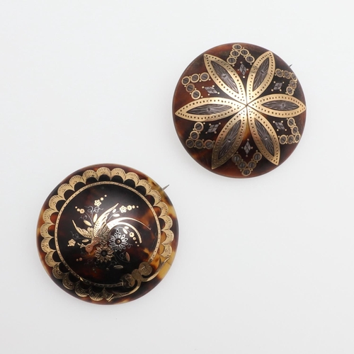 1002 - TWO PIQUE BROOCHES. of circular form, one depicting a bird amongst foliatge,4.0cm dia., the other de... 