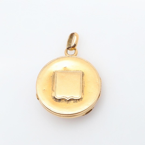 1004 - A GOLD AND GEM SET LOCKET PENDANT. of circular form, mounted to the front with rose-cut diamonds and... 