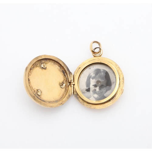 1004 - A GOLD AND GEM SET LOCKET PENDANT. of circular form, mounted to the front with rose-cut diamonds and... 