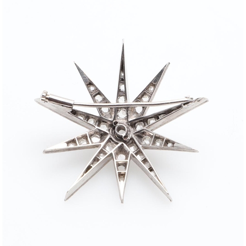 1006 - A VICTORIAN DIAMOND STAR BROOCH. centred with a circular old-cut diamond, the rays mounted with rose... 