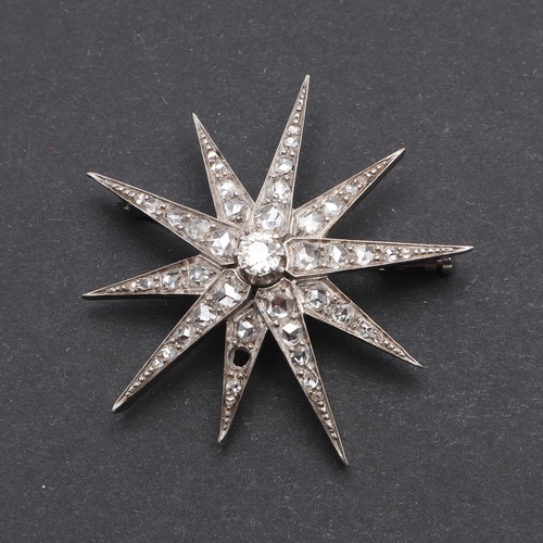 1006 - A VICTORIAN DIAMOND STAR BROOCH. centred with a circular old-cut diamond, the rays mounted with rose... 