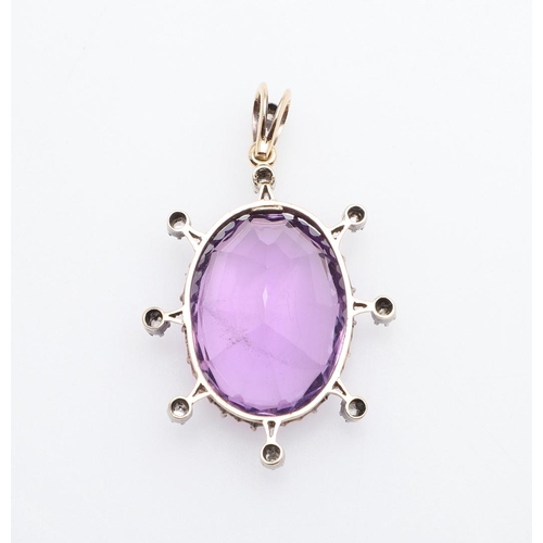 1008 - A VICTORIAN AMETHYST AND DIAMOND PENDANT. the oval-shaped amethyst is set within a surround of rose-... 