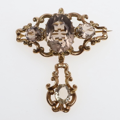 1013 - A VICTORIAN CITRINE AND GOLD BROOCH. the ornate gold mount is set with three oval-shaped citrines, s... 