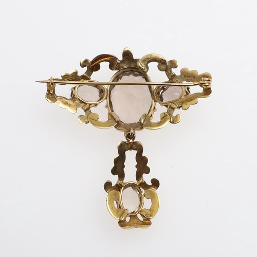 1013 - A VICTORIAN CITRINE AND GOLD BROOCH. the ornate gold mount is set with three oval-shaped citrines, s... 