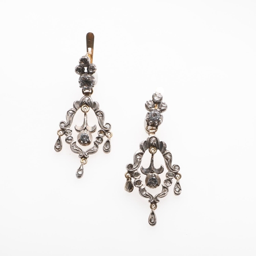 1025 - A PAIR OF VICTORIAN PASTE SET DROP EARRINGS. each earring of openwork scrolling form, mounted with w... 