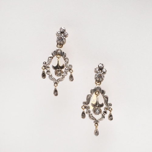 1025 - A PAIR OF VICTORIAN PASTE SET DROP EARRINGS. each earring of openwork scrolling form, mounted with w... 