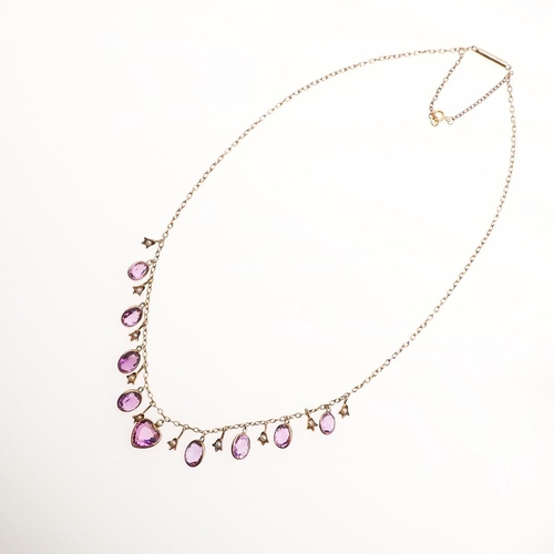 1026 - AN AMETHYST, PEARL AND GOLD DROP NECKLACE. centred with a heart-shaped amethyst drop and alternately... 