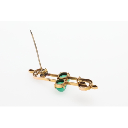 1027 - A CHRYSOPRASE AND GOLD BROOCH. the scrolling openwork mount is centred with two chrysoprase cabochon... 