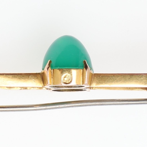 1027 - A CHRYSOPRASE AND GOLD BROOCH. the scrolling openwork mount is centred with two chrysoprase cabochon... 