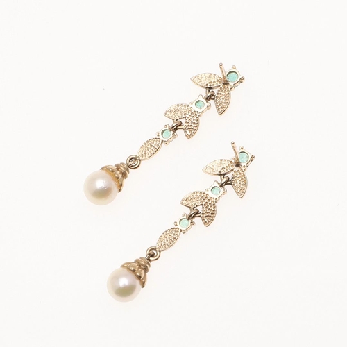 1036 - A PAIR OF EMERALD AND PEARL DROP EARRINGS. of foliate form, set with circular-cut emeralds and half ... 