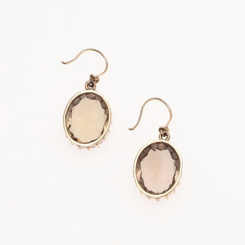 1039 - A PAIR OF SMOKY QUARTZ DROP EARRINGS. each earring mounted with an oval-shaped smoky quartz in gold,... 