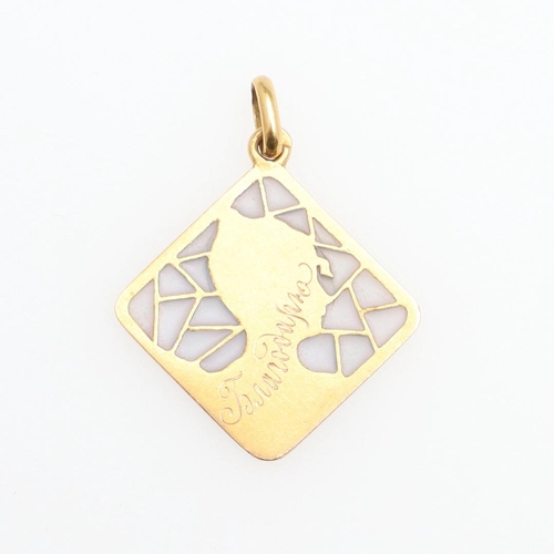 1054 - AN ART NOUVEAU PLIQUE A JOUR ENAMEL, GOLD AND DIAMOND PENDANT. depicting the profile of a lady weari... 