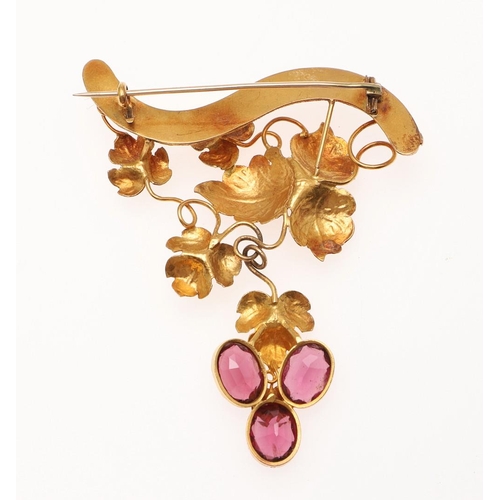 1061 - A VICTORIAN GARNET AND GOLD BROOCH. the fruiting vine gold mount suspends three oval-shaped garnets,... 