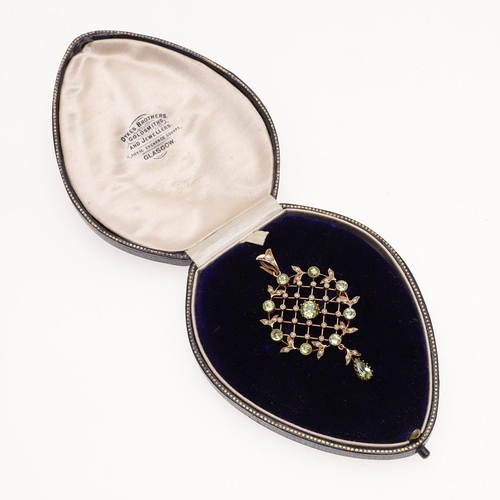 1062 - A PERIDOT AND PEARL BROOCH PENDANT. the 9ct gold mount of lattice design, set with circular-cut peri... 