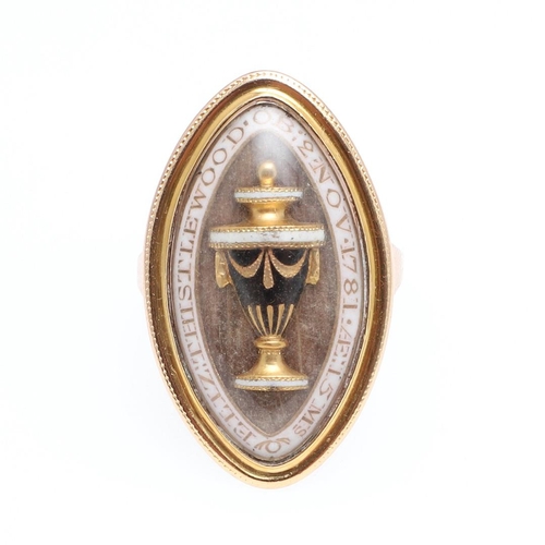 1068 - A GEORGE III GOLD AND ENAMEL MOURNING RING. of navette-shape, the centre section containing hair and... 