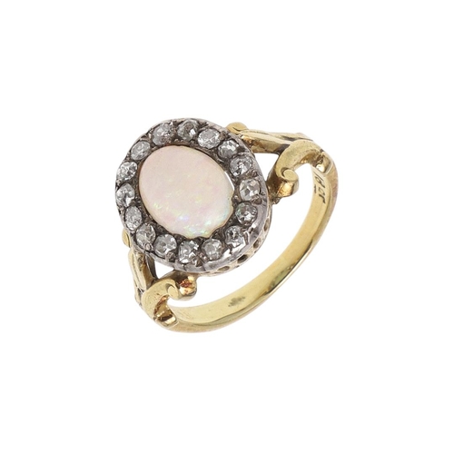 1070 - AN OPAL AND DIAMOND CLUSTER RING. the oval-shaped solid white opal is set within a surround of old-c... 