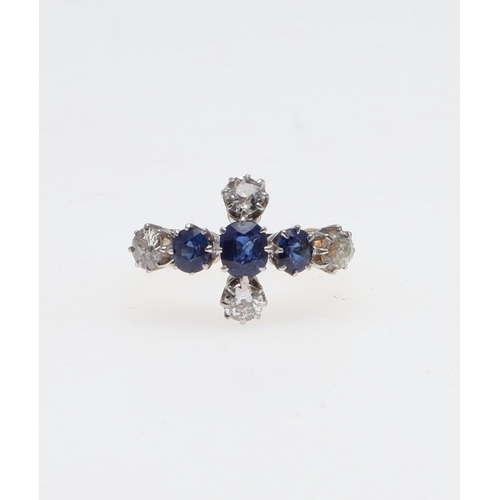 1071 - A SAPPHIRE AND DIAMOND QUATREFOIL CLUSTER RING. mounted with three oval-shaped sapphires and four ci... 