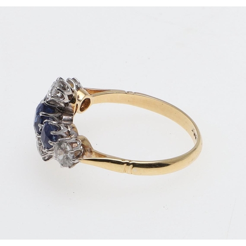 1071 - A SAPPHIRE AND DIAMOND QUATREFOIL CLUSTER RING. mounted with three oval-shaped sapphires and four ci... 