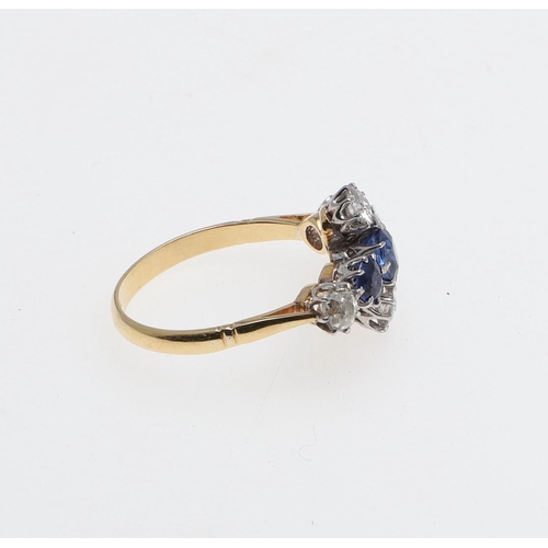 1071 - A SAPPHIRE AND DIAMOND QUATREFOIL CLUSTER RING. mounted with three oval-shaped sapphires and four ci... 