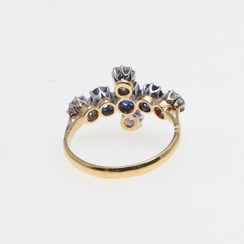 1071 - A SAPPHIRE AND DIAMOND QUATREFOIL CLUSTER RING. mounted with three oval-shaped sapphires and four ci... 